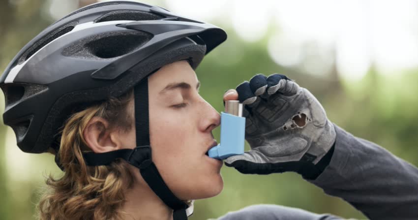 Ciclista che usa broncodilatatore per asma
