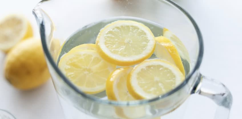 Brocca d'acqua calda con limone per combattere la gastrite